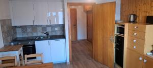 a kitchen with a sink and a counter top at Studio Bellevue Veysonnaz in Veysonnaz