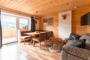 a living room with a table and a couch at Westendorf Alpen Lodge in Westendorf