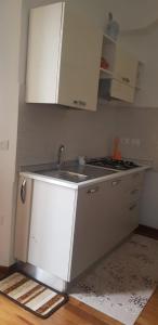a kitchen with a sink and a stove at In Centro a Senigallia in Senigallia