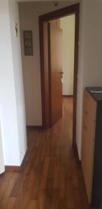 an empty room with a door and a wooden floor at In Centro a Senigallia in Senigallia
