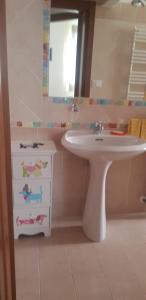 a bathroom with a white sink and a mirror at In Centro a Senigallia in Senigallia