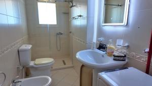 a bathroom with a sink and a toilet and a shower at Casa sul Mare in Vlorë +22 photos