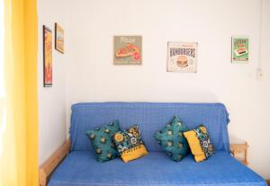 a blue couch with pillows in a room at Loft Grazioso - Pescara in Pescara