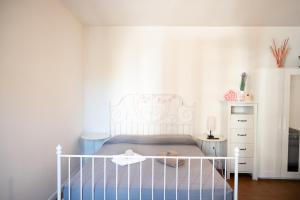a bedroom with a white bed and a white dresser at Loft Grazioso - Pescara in Pescara