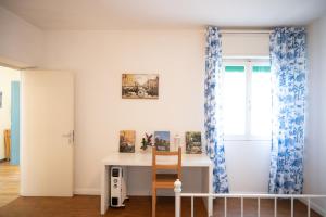 a room with a desk with a chair and a window at Loft Grazioso - Pescara in Pescara +19 photos