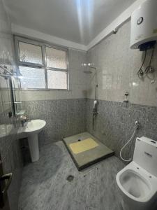 a bathroom with a toilet and a sink at Home Away From Home in Addis Ababa