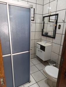 a bathroom with a shower and a toilet and a sink at Casa em Itapema in Itapema