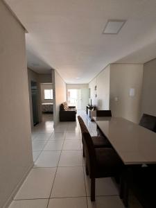 une cuisine et un salon avec une table et des chaises dans l'établissement Apartamento espaçoso e localização perfeita, à Petrolina