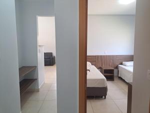 Ένα ή περισσότερα κρεβάτια σε δωμάτιο στο Lagoa Jardins com Café da Manhã e Parque Aquático Incluso +23 φωτογραφίες