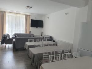 a living room with four beds and a couch at Casa Bogdan in Uricani