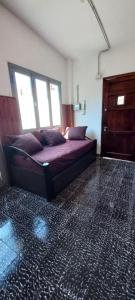 a bedroom with a bed in a room with windows at Departamento Silvi in Jesús María