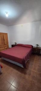 a bedroom with a red bed and two night stands at Departamento Silvi in Jesús María