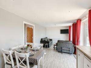 a kitchen and living room with a table and chairs at Hill Crest Lodge 1 in Hemswell