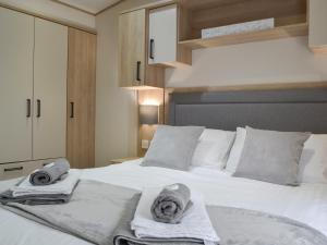 a bedroom with a bed with towels on it at Graylings Rest - Uk35759 in Brigham +15 photos