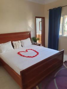 a bedroom with a bed with a heart on it at Maya, Entire Apartment, Mbour, 3 air-conditioned bedrooms in Mbour