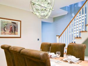 a dining room with a table with chairs and a chandelier at Lowey's Harbour Cottage in Bridlington