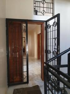 an open door to a hallway with a staircase at Maya, Entire Apartment, Mbour, 3 air-conditioned bedrooms in Mbour +7 photos