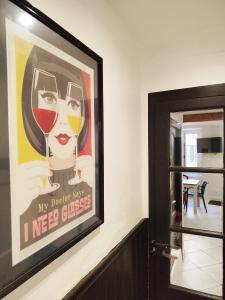 a painting of a woman with a glass of wine on a wall at Maison avec jardin aux Cabannes - Ariège in Les Cabannes