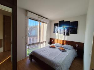 Ένα ή περισσότερα κρεβάτια σε δωμάτιο στο Appartement Le Cocon du Monde