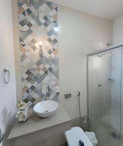 a bathroom with a sink and a shower at Sobrado 2 amplo e confortável em condomínio in Corumbá