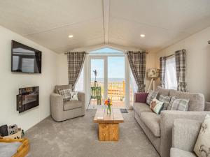 a living room with a couch and a table at Burray in Mey