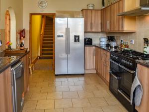 a kitchen with a refrigerator and a stove at St Judes in Mundesley +22 photos