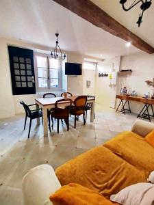 a large living room with a table and chairs at Maison avec jardin aux Cabannes - Ariège in Les Cabannes