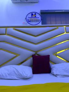 a bed in a room with a sign on the wall at Spacious and luxurious studio apartment in OguduGRA in Lagos