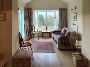 a living room with a couch and a table at Overwater Lodge in Bassenthwaite Lake