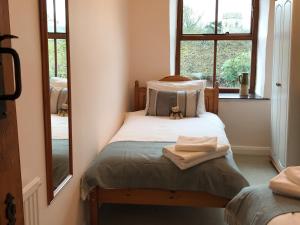 a small bedroom with a bed with a teddy bear on it at Foal Barn Cottages - Hayloft - Spennithorne in Middleham