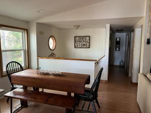a dining room with a wooden table and chairs at 20 Mile Bay Lake View 4 Bedroom Public Beach Pet Friendly fee applies in Tuftonboro
