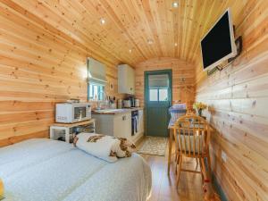 a bedroom with a bed in a wooden cabin at Cater Tober Haven in Dunnet
