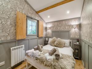 a bedroom with a large white bed with a blanket at The Lodge - Uk50409 in Bisterne