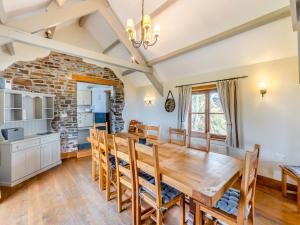 a kitchen and dining room with a wooden table and chairs at Atlantic House in Bideford
