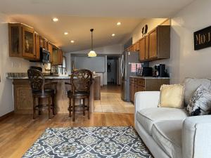 a living room with a couch and a kitchen at 20 Mile Bay Lake View 4 Bedroom Public Beach Pet Friendly fee applies in Tuftonboro