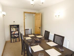 a dining room with a table and chairs at Shippon Cottage - E4299A in Halston