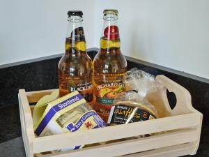 three bottles of beer in a wooden crate at Little Barn in Gilwern