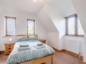 a bedroom with a bed with two pillows on it at The Paddocks in Lowestoft