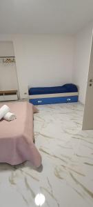 a bedroom with a bed and a hand on the floor at La piazza in San Giorgio la Molara +24 photos