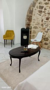 a coffee table and a chair in a room at La piazza in San Giorgio la Molara