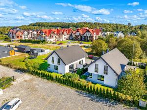 an aerial view of a residential neighborhood with houses at Domki apartamentowe Na wrzosach in Jastrzębia Góra