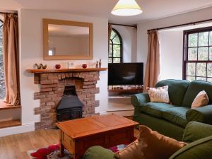 a living room with a couch and a fireplace at The Farmhouse - Ukc1339 in North Molton