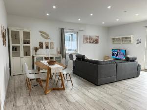 a living room with a couch and a table at SleepShop in Nordhausen