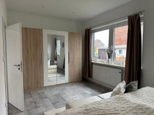a bedroom with a bed and a large window at SleepShop in Nordhausen