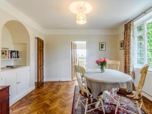 a dining room with a table with a vase of flowers on it at Henrys Retreat in Ingoldsby
