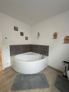 a large white bath tub in a room at SleepShop in Nordhausen