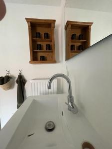 a kitchen counter with a sink and a mirror at Landhaus Johann in Mürzzuschlag