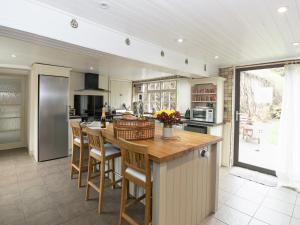 a kitchen with a large island with bar stools at Greenlands Farmhouse in Barmby on the Moor