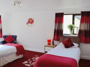 a hotel room with two beds and a window at River View Villa - Cv44 in Saint Cleer