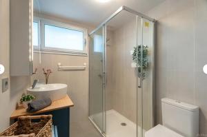 a bathroom with a shower and a sink and a toilet at Tejita Beach in La Tejita +25 photos